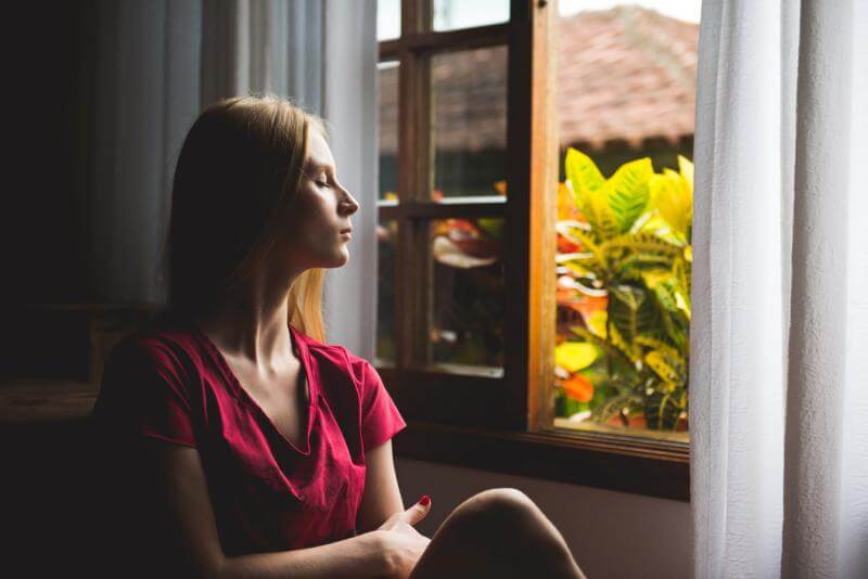 Woman sitting by an open window